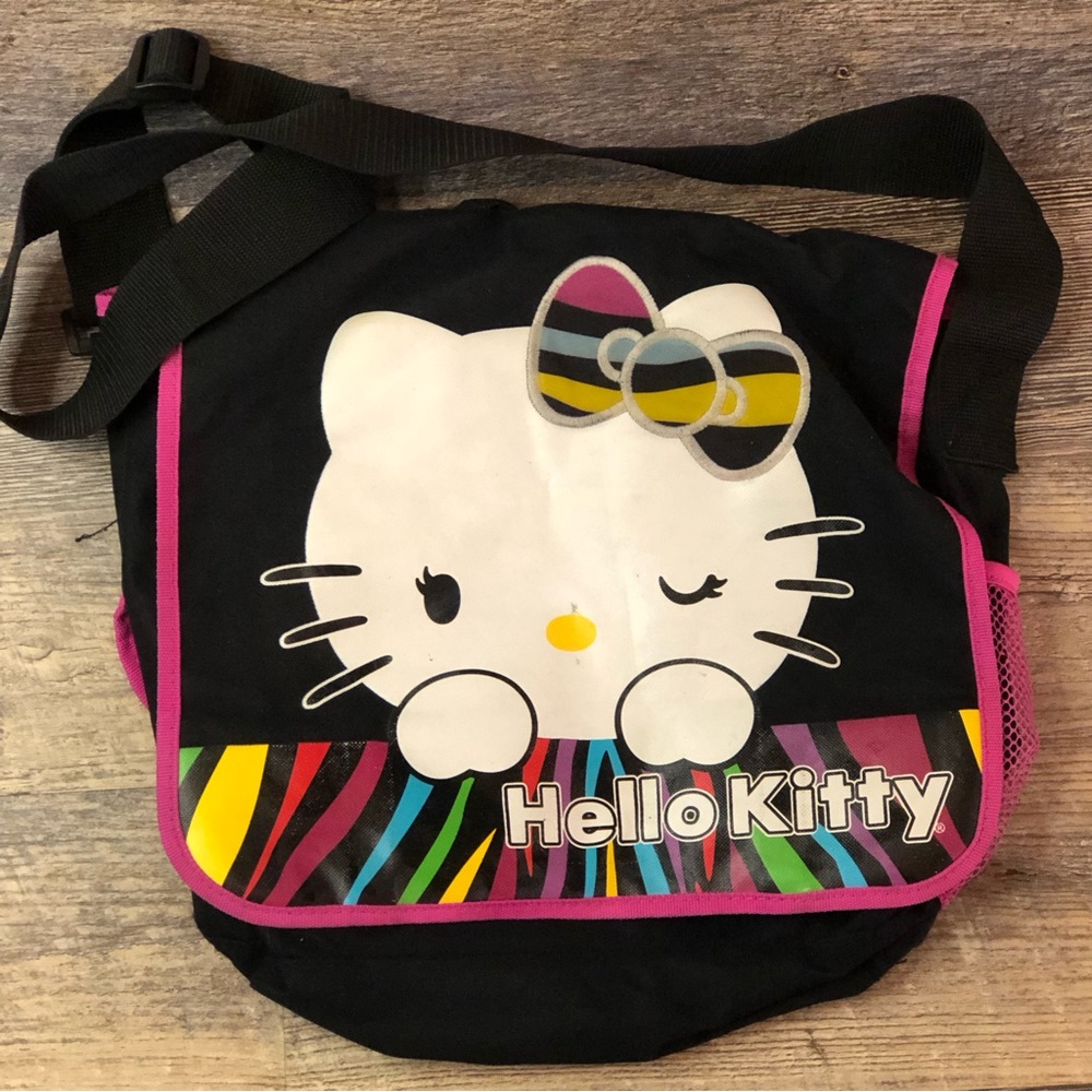 Hello Kitty Messenger Bag black and pink used condition.  Missing zipper piece
